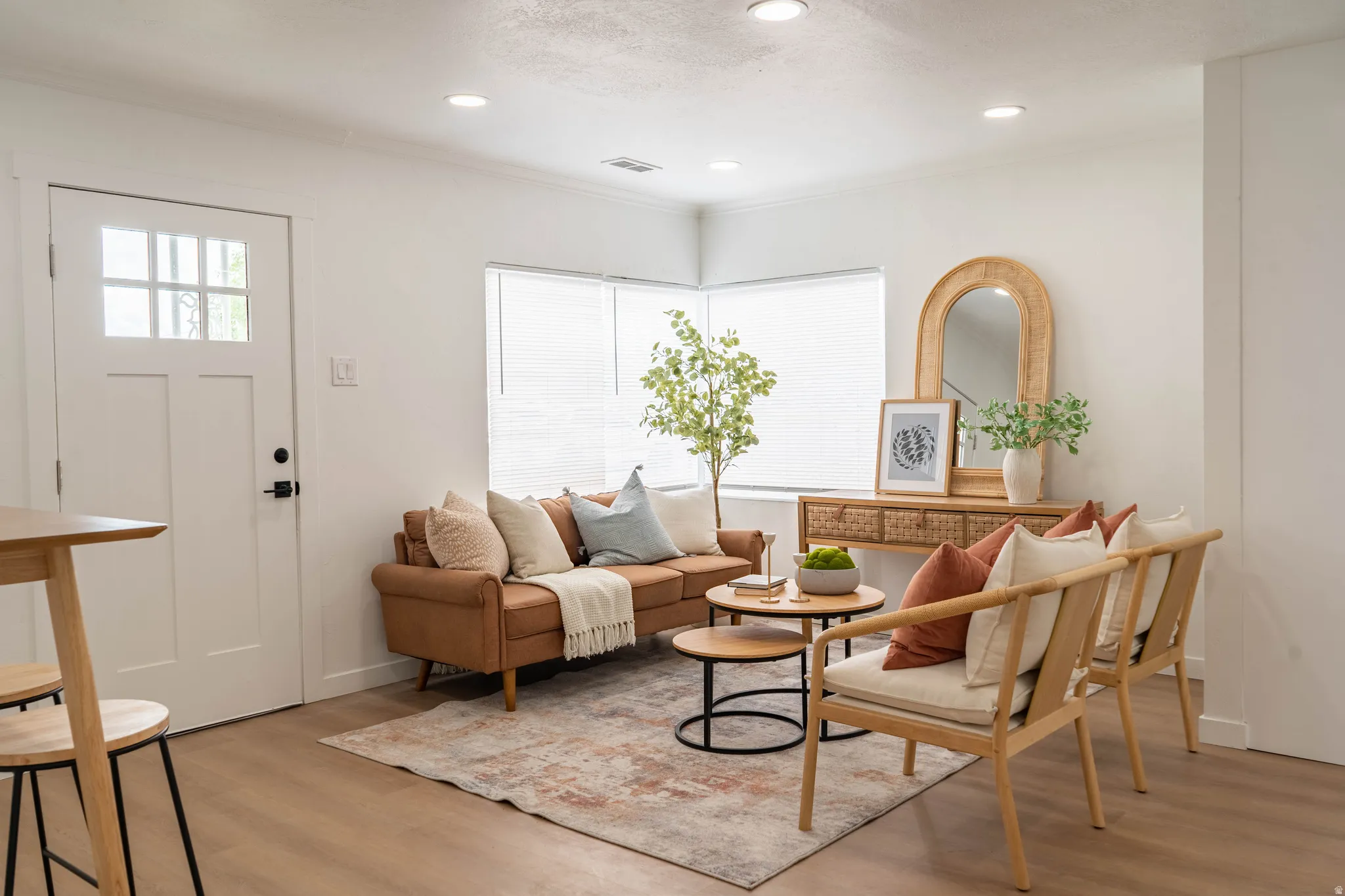 Living area with wood-finish flooring, recessed lighting, and ample natural light from multiple windows
