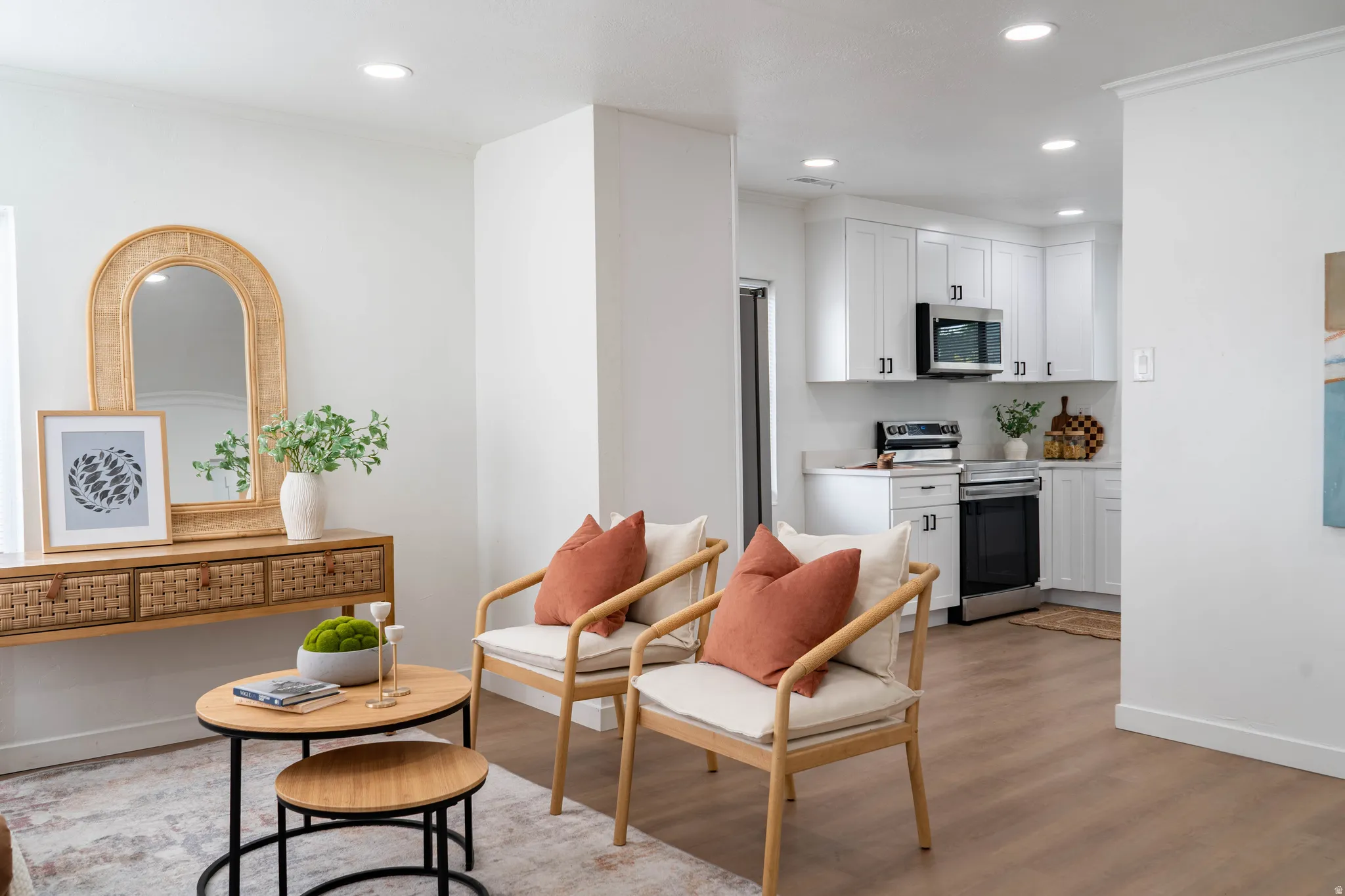 Open-concept living area featuring wood-finish flooring, recessed lighting, and a neutral color palette