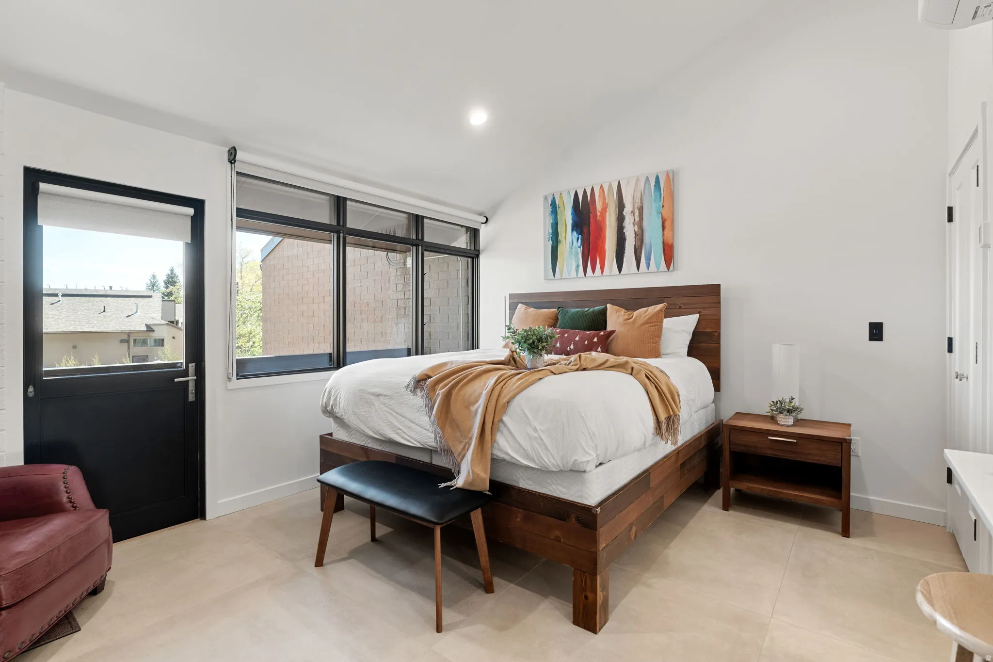 Vaulted ceiling accentuates the bright white walls and light-toned flooring