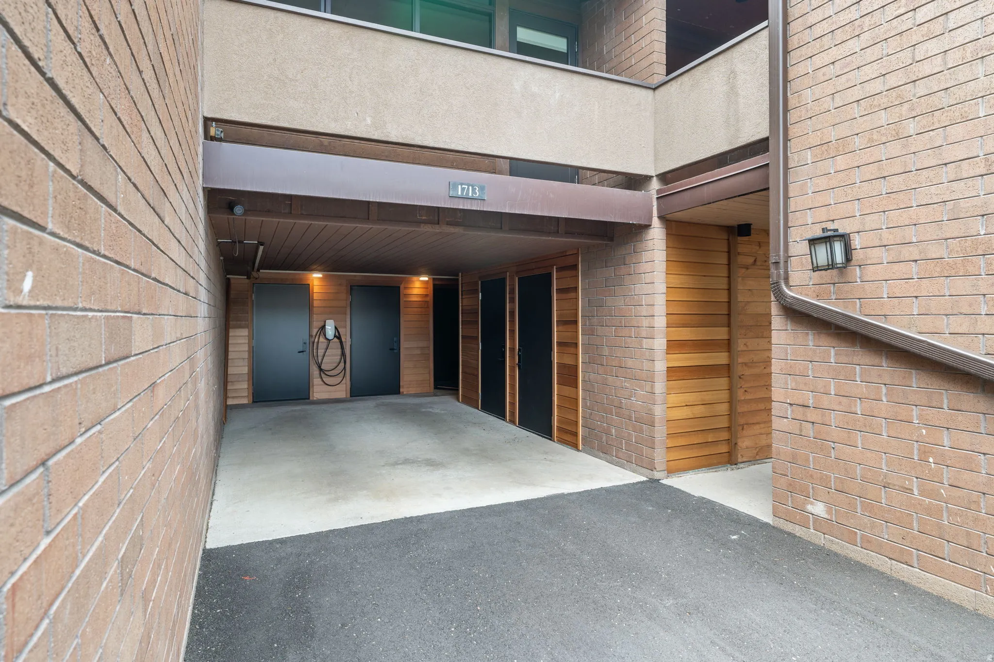 Covered parking area with concrete and asphalt surfacing