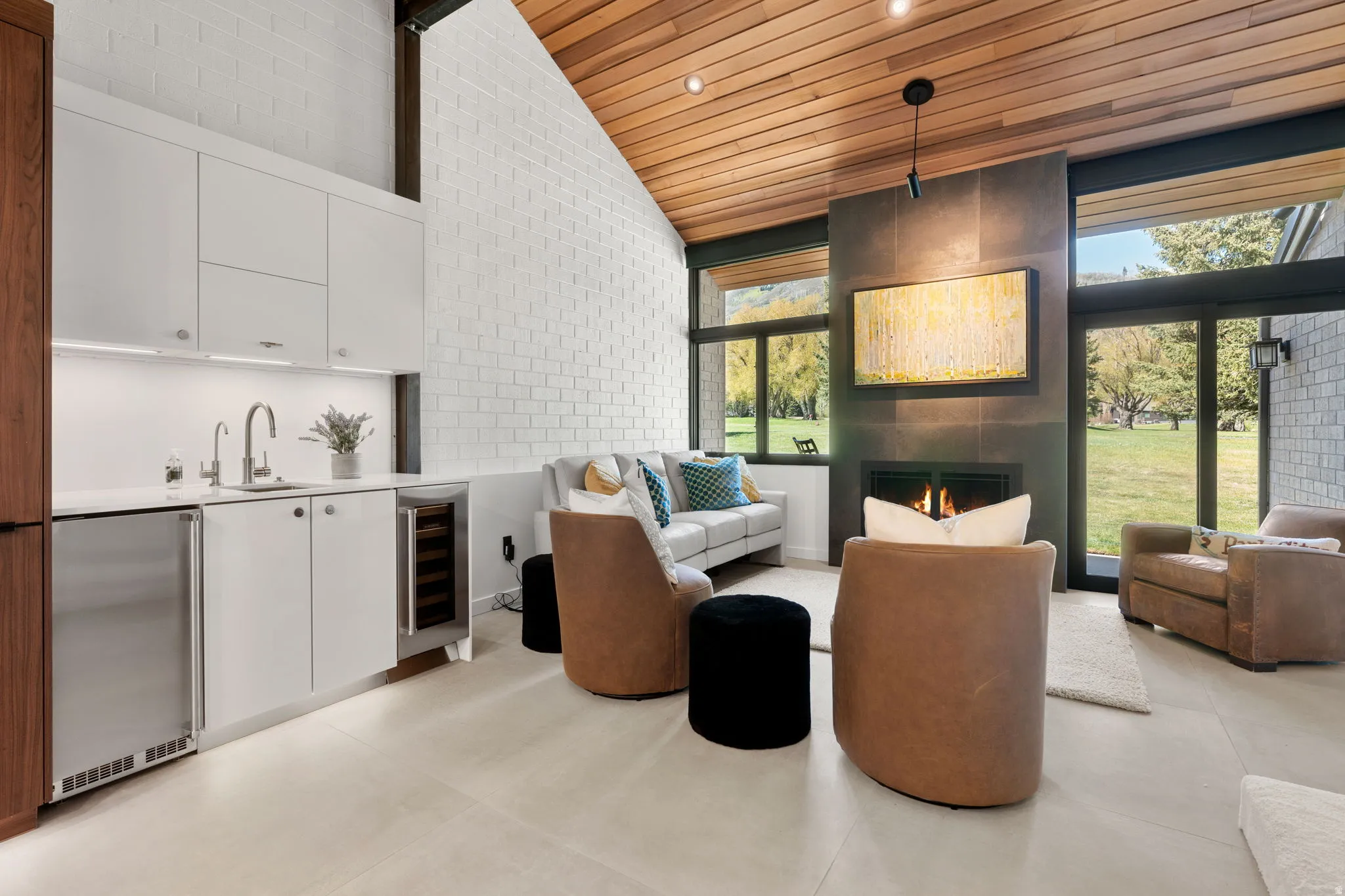 Vaulted wood-finish ceiling over a contemporary living space with a large fireplace