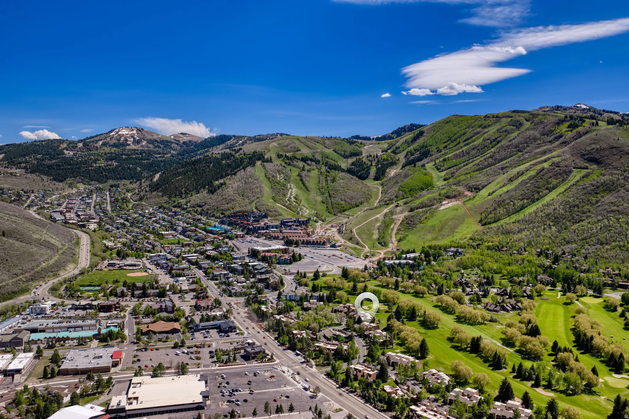 Aerial perspective showcasing a mountain community with extensive green spaces