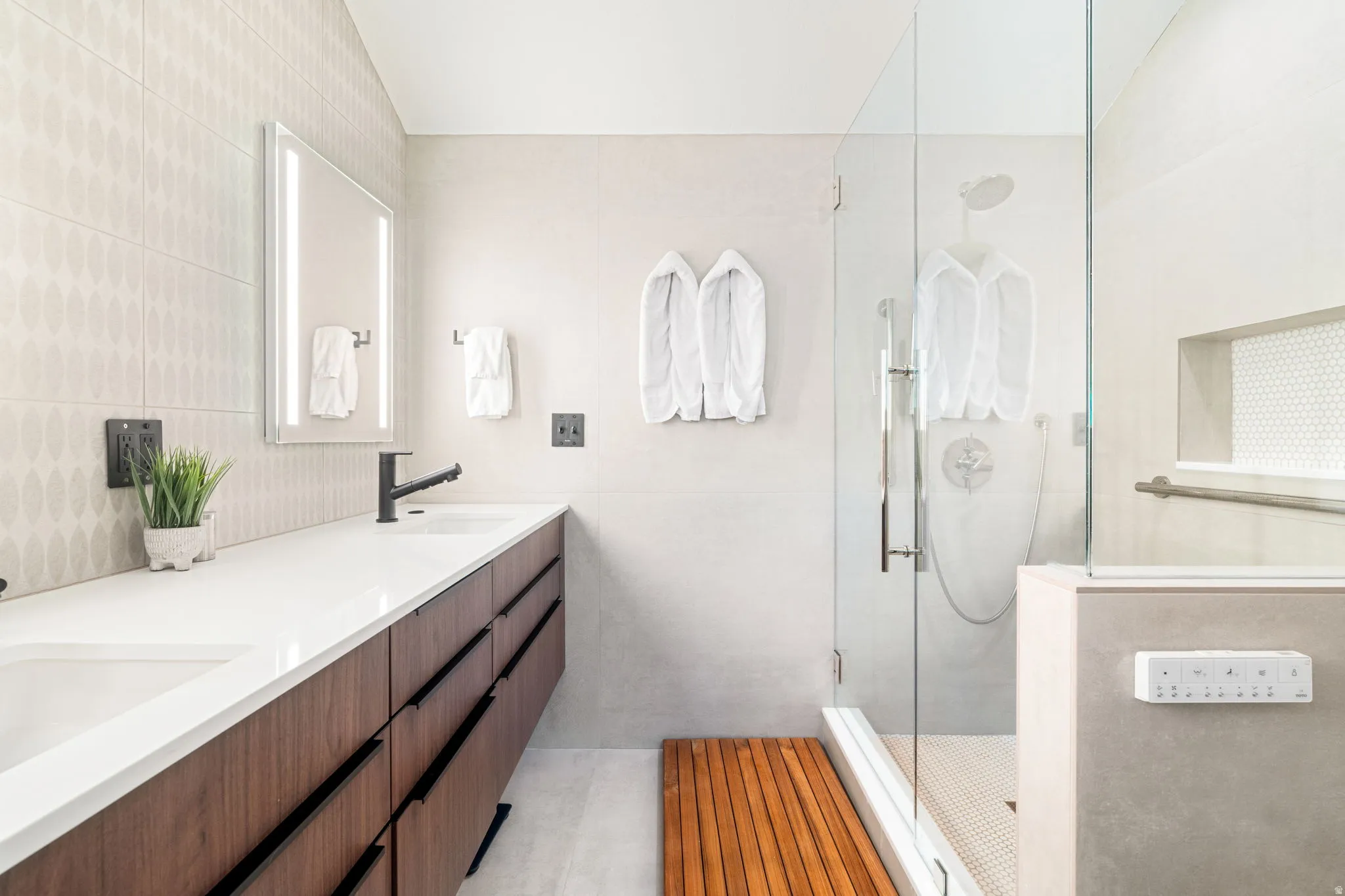 Double vanity with a white countertop and wood-finish cabinetry