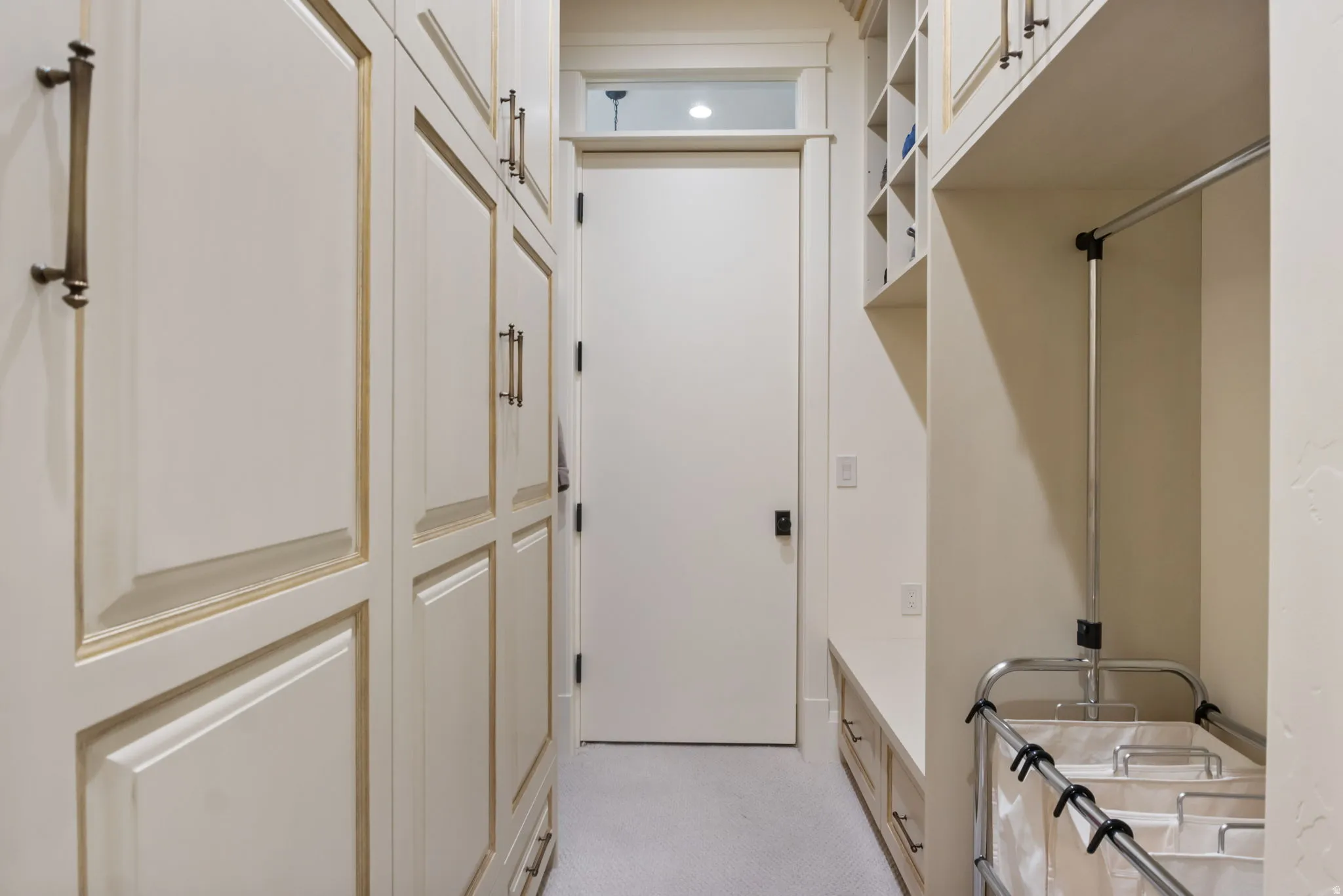 Hallway with built-in cabinetry, an integrated clothes hanging rod, and additional shelving