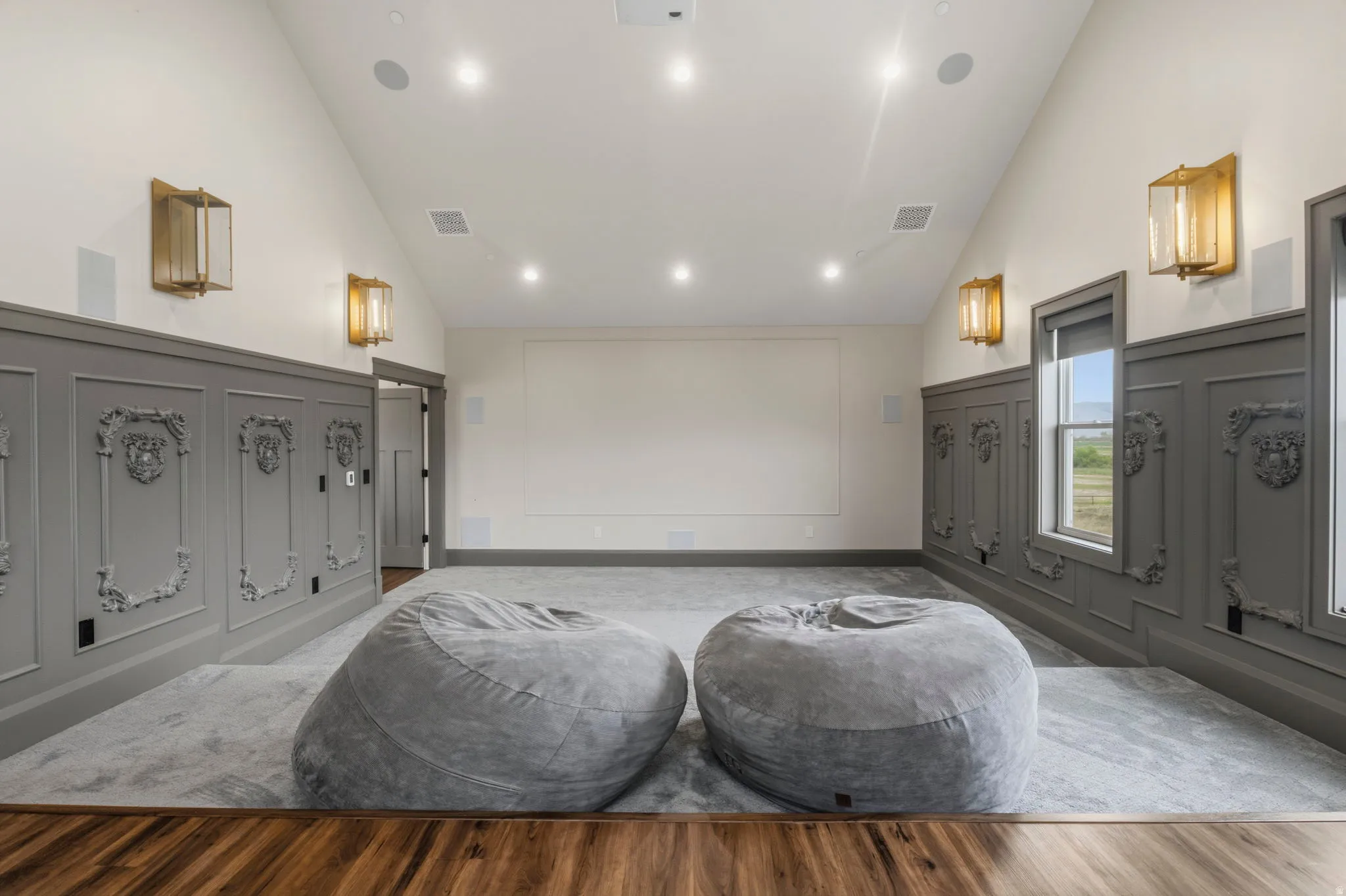 Parlor style Theatre/Media room featuring decorative wainscoting, recessed lighting, and wall-mounted sconces