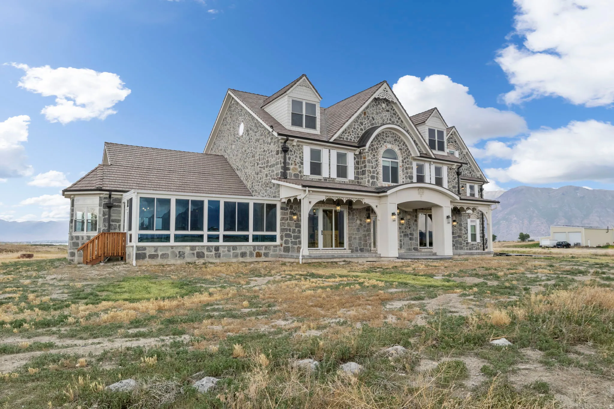 Stone facade exterior with multiple dormer windows and Solarium.