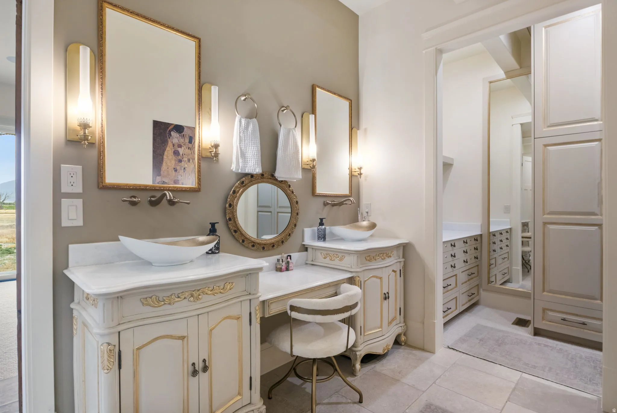 Dual vanity with vessel sinks and ornate cabinetry