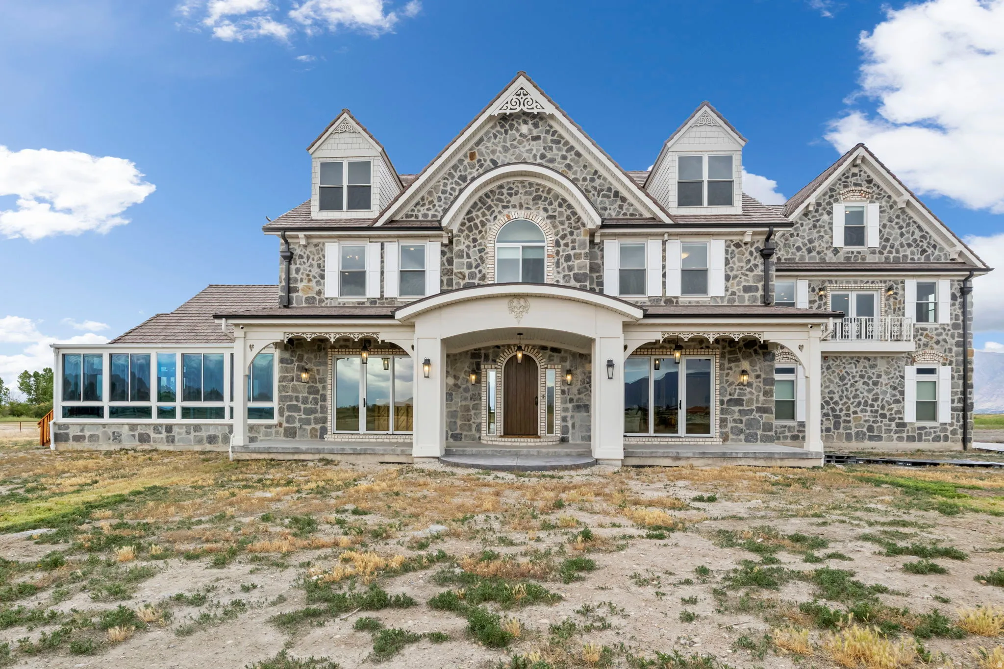 Grand stone facade featuring multiple gables and dormer windows