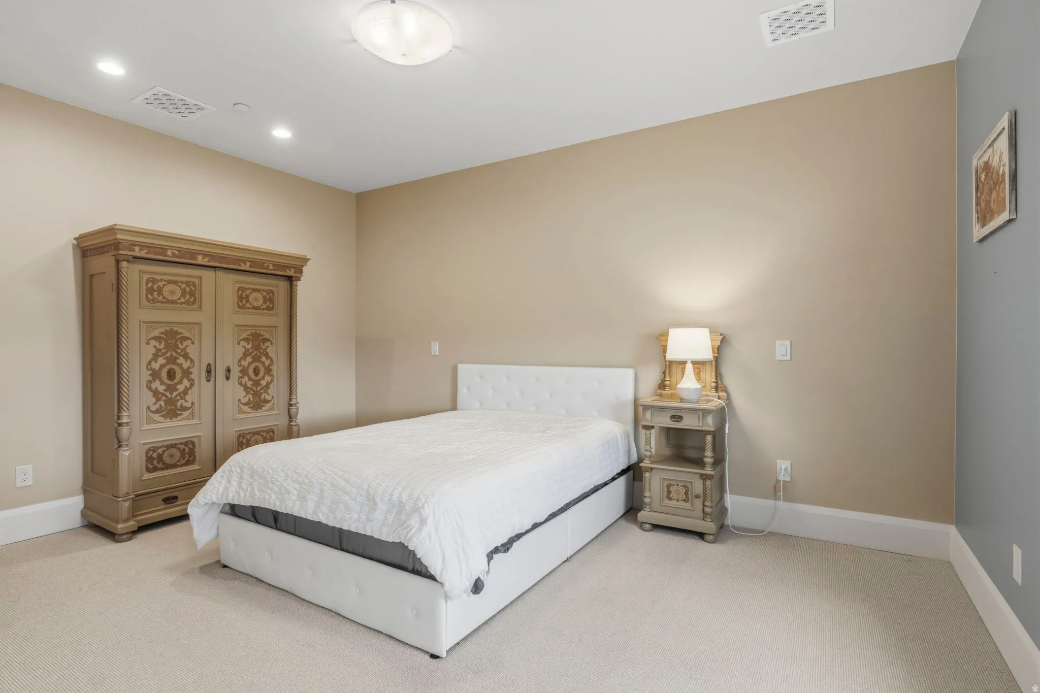 Spacious room featuring neutral carpeting, a tray ceiling with recessed lighting, and crown molding