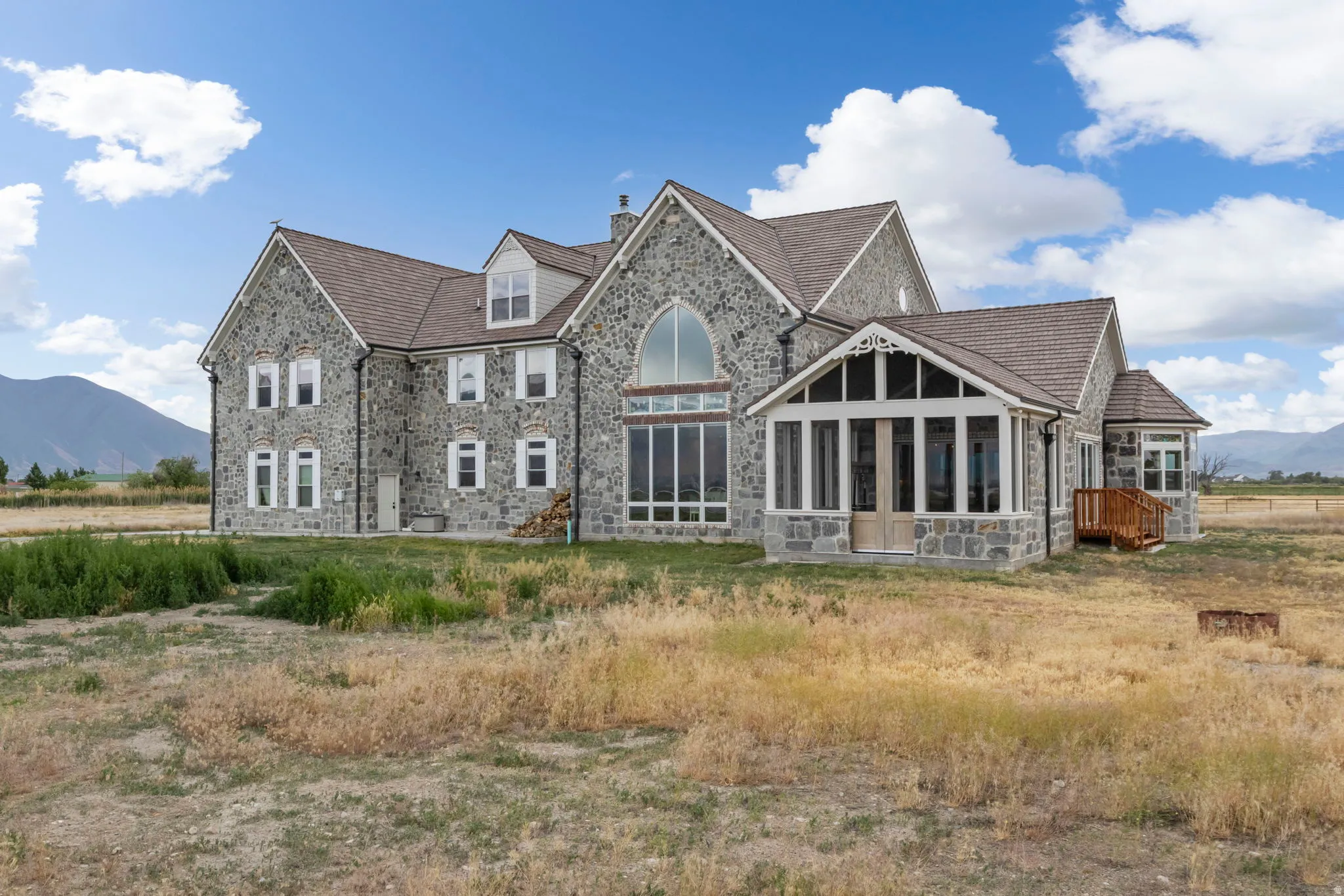 Stone-clad exterior featuring multiple gables and dormer windows