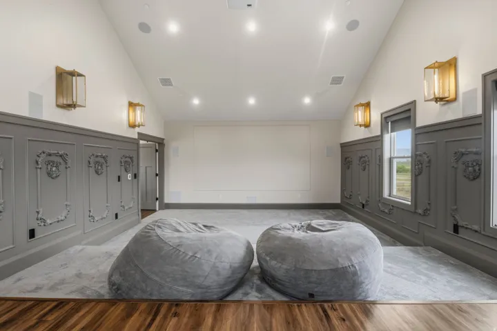 Parlor style Theatre/Media room featuring decorative wainscoting, recessed lighting, and wall-mounted sconces
