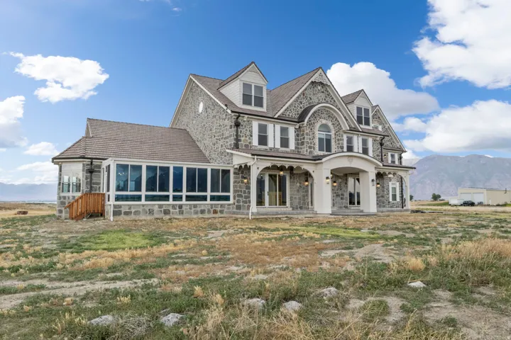 Stone facade exterior with multiple dormer windows and Solarium.