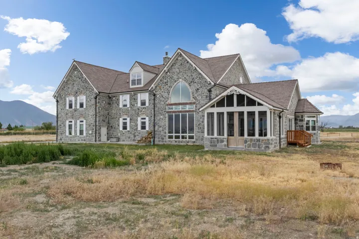 Stone-clad exterior featuring multiple gables and dormer windows