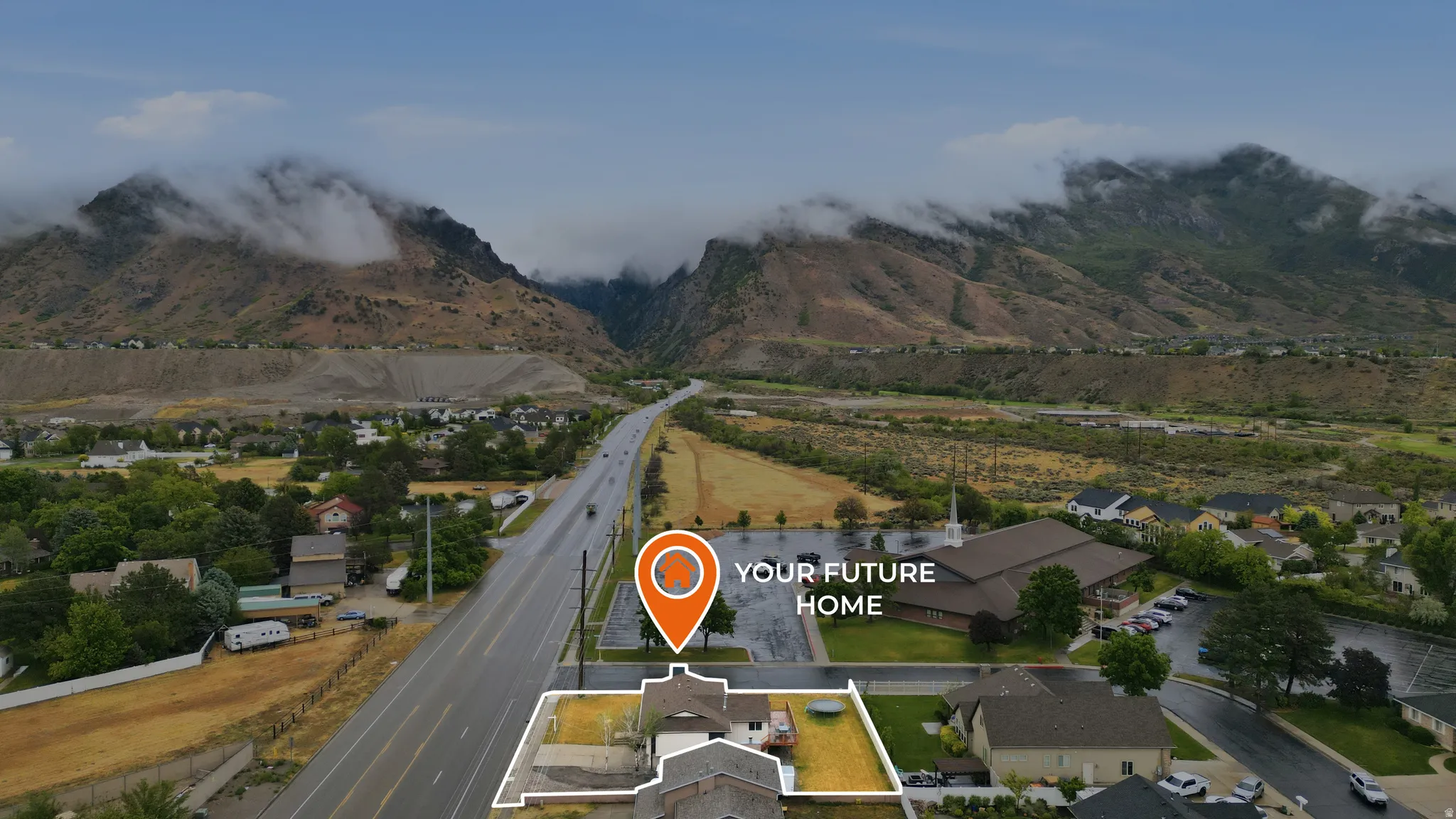 Aerial perspective showcasing a residential property with a defined lot, positioned near a main thoroughfare