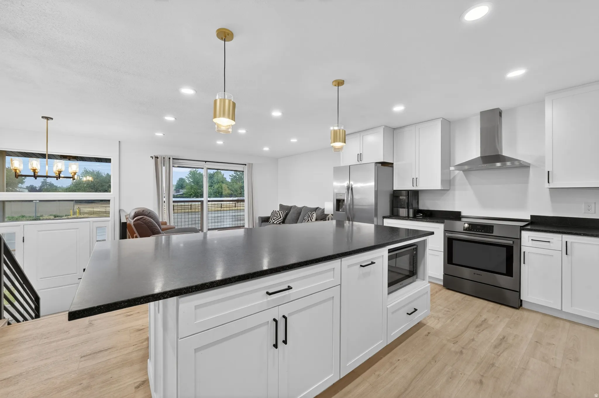 Spacious kitchen island with dark stone countertop