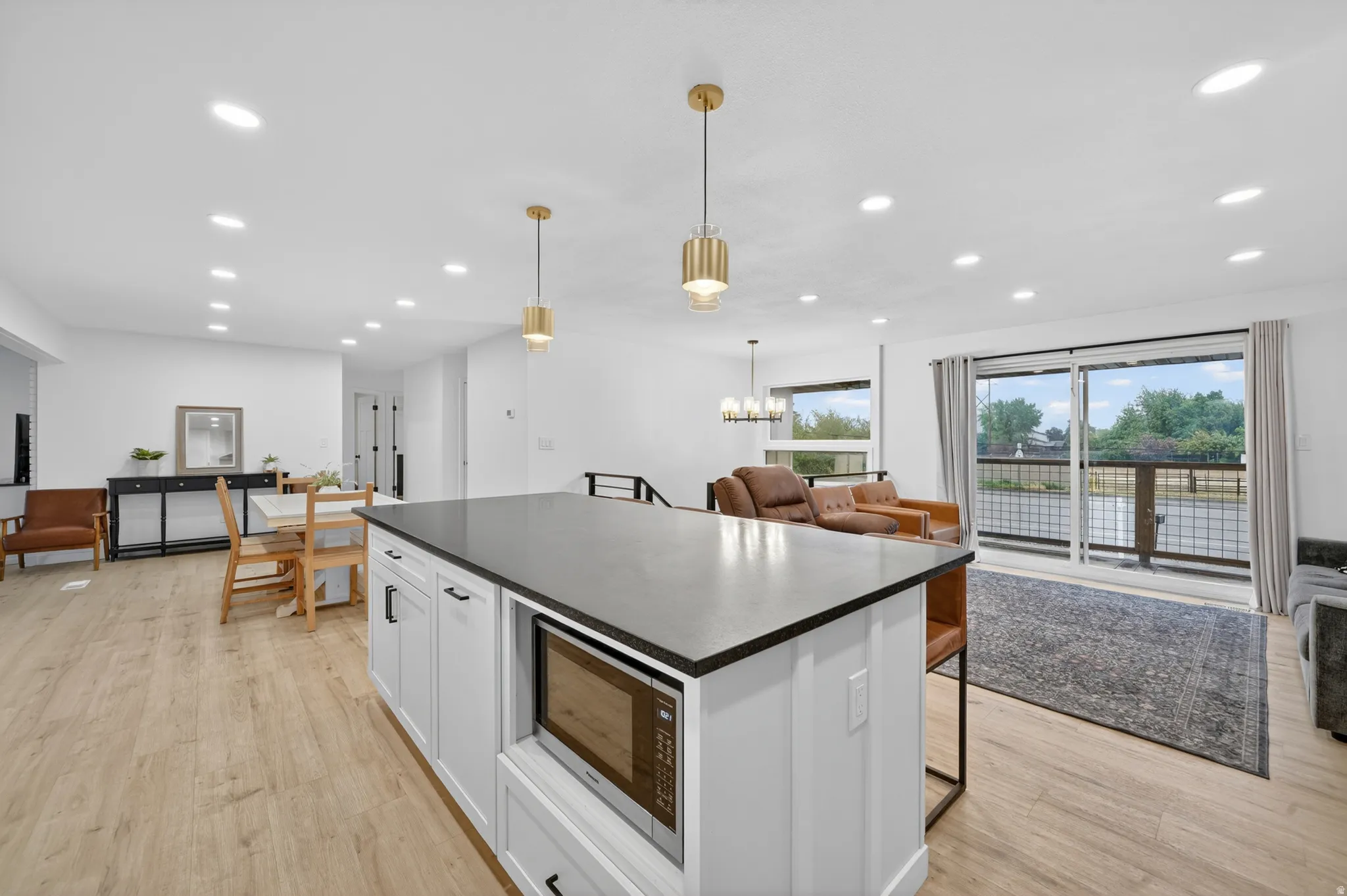 Kitchen island with a dark countertop and integrated microwave
