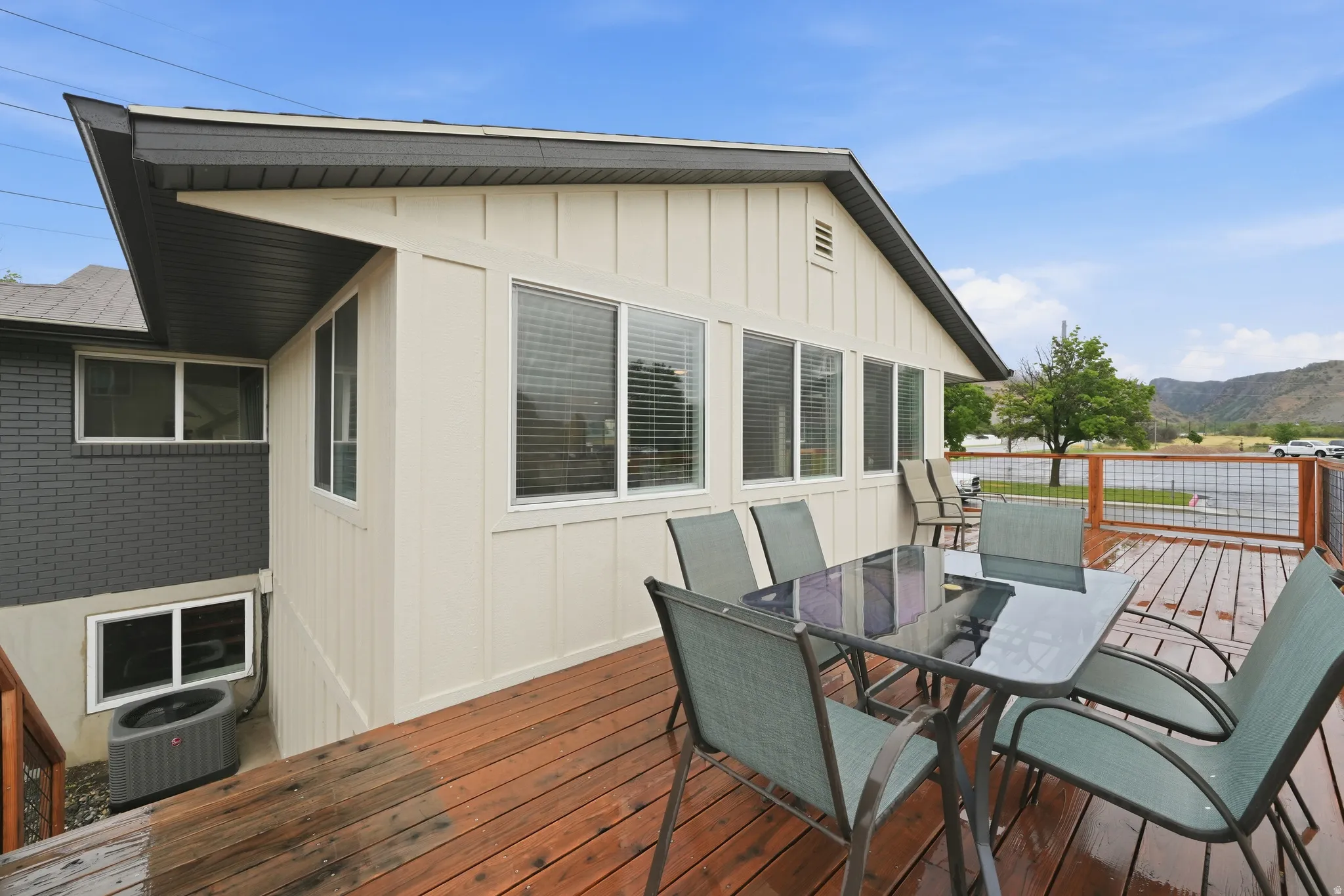 Expansive wooden deck with a slatted railing and metal grid accents