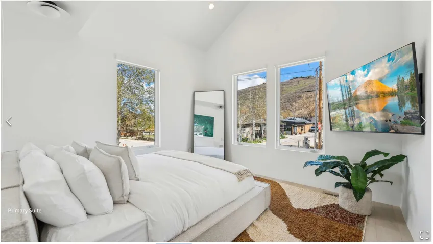 Vaulted white ceilings featuring a ceiling fan