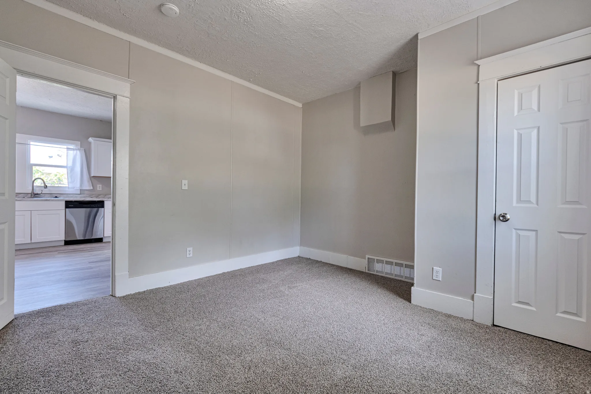 Carpeted room with light gray walls and white trim