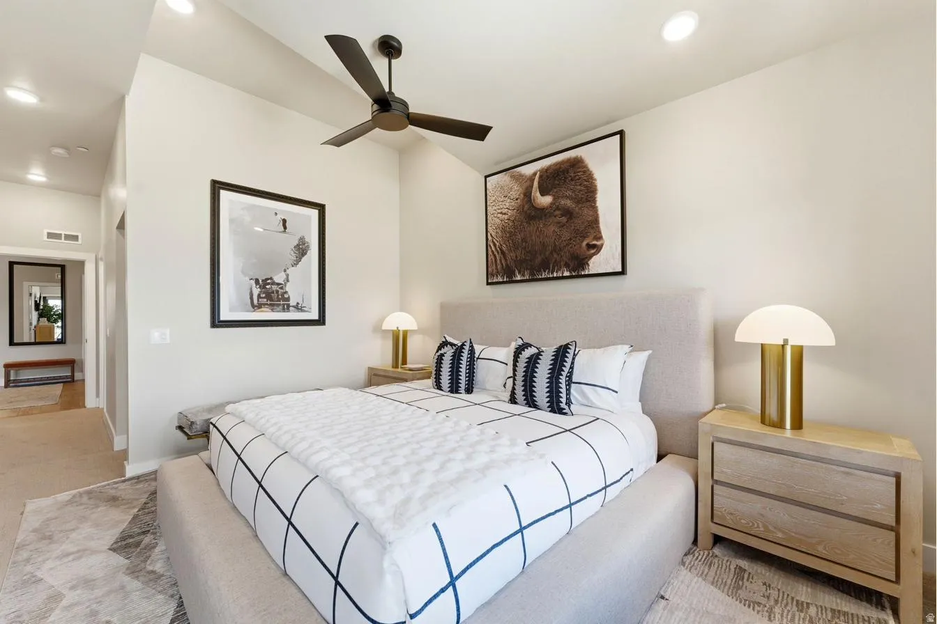 Bedroom featuring a black ceiling fan, recessed lighting, and a neutral color palette
