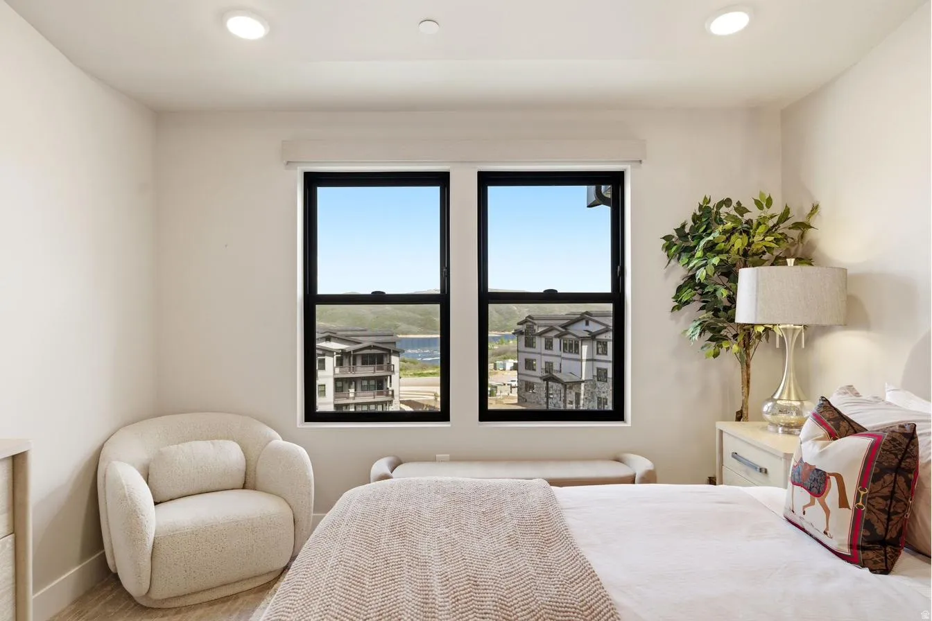 Bedroom featuring dual black-framed windows