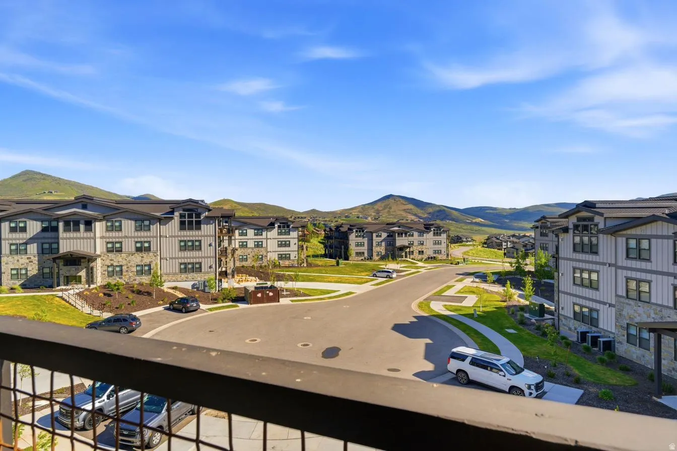 Expansive mountain scenery framing modern multi-story buildings with stone and siding exteriors