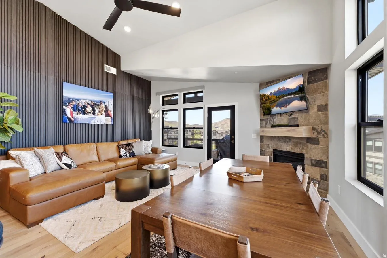 Open-concept living area with a vaulted ceiling and exposed beam