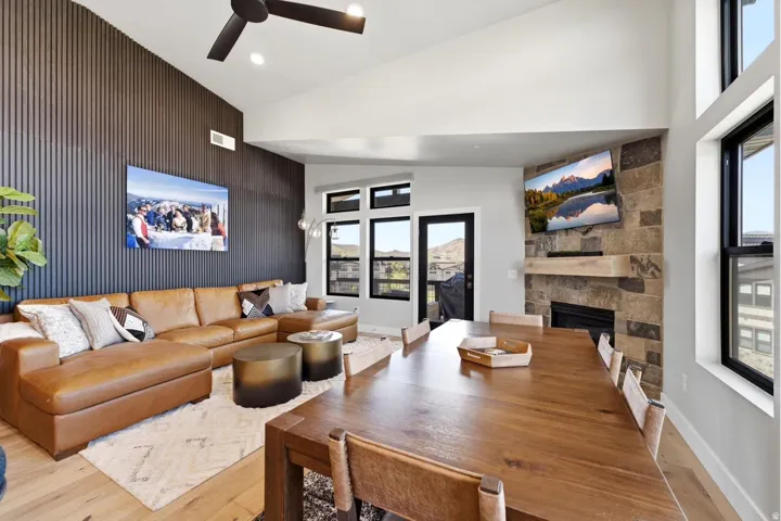 Open-concept living area with a vaulted ceiling and exposed beam