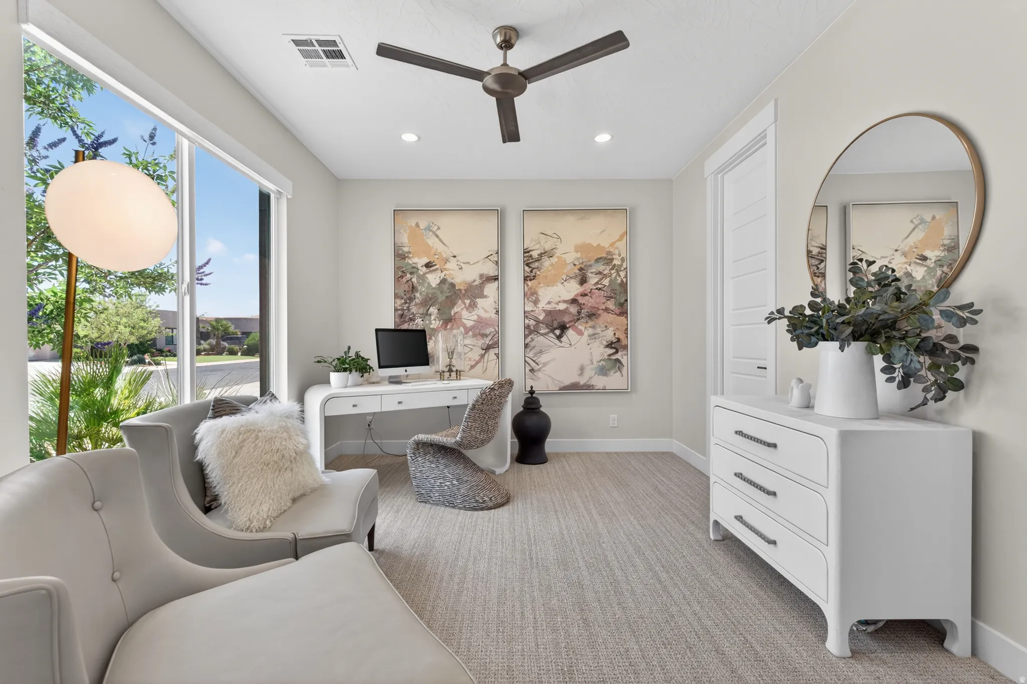 Bright interior space featuring large windows, recessed lighting, and a ceiling fan