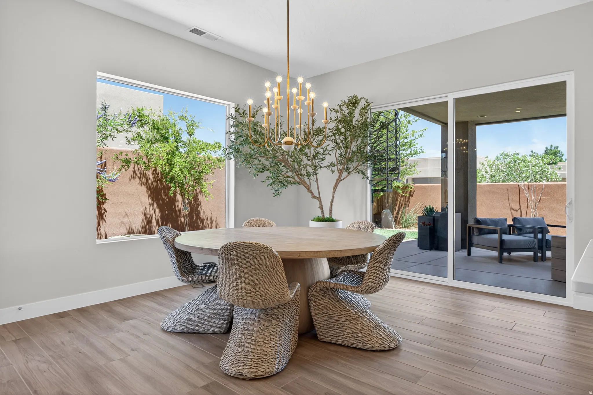Dining area featuring wood-finish flooring and a contemporary chandelier