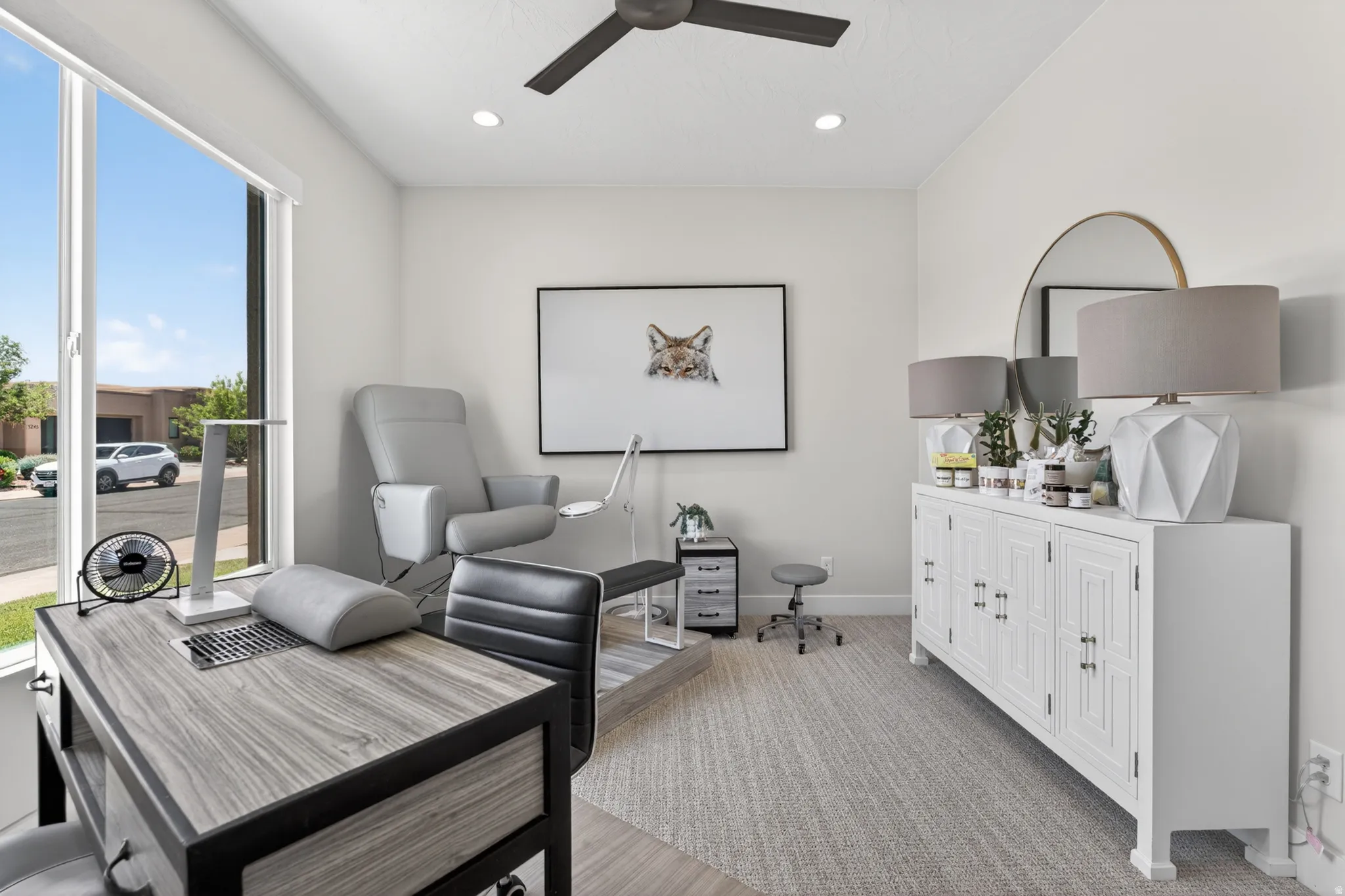 Bright room featuring a large window, recessed lighting, and a ceiling fan