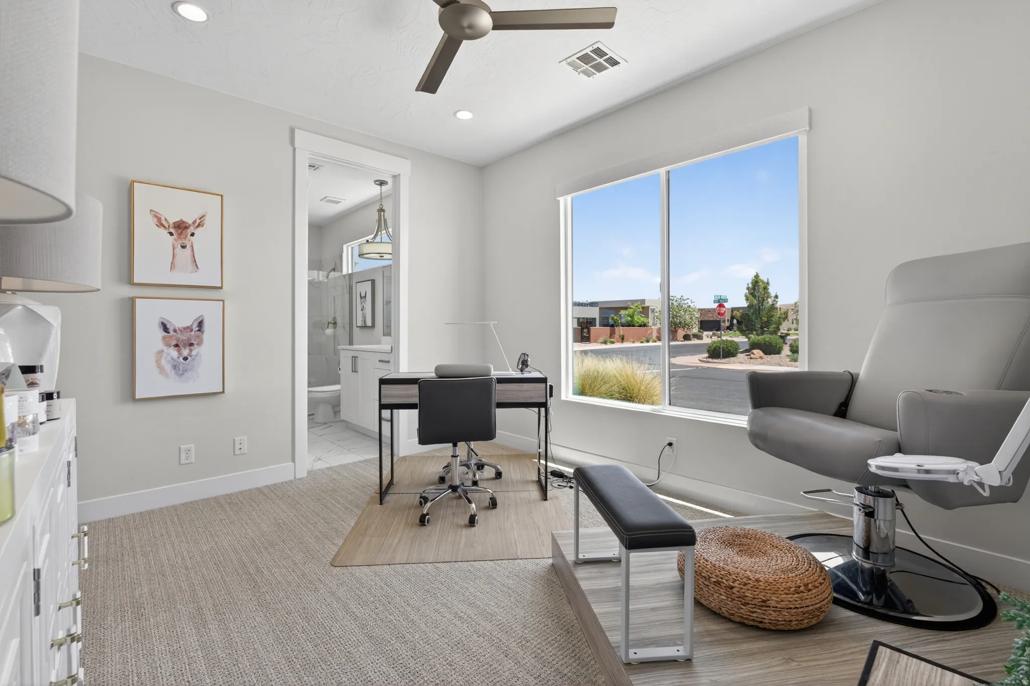 Bright room featuring a large window, recessed lighting, and a ceiling fan