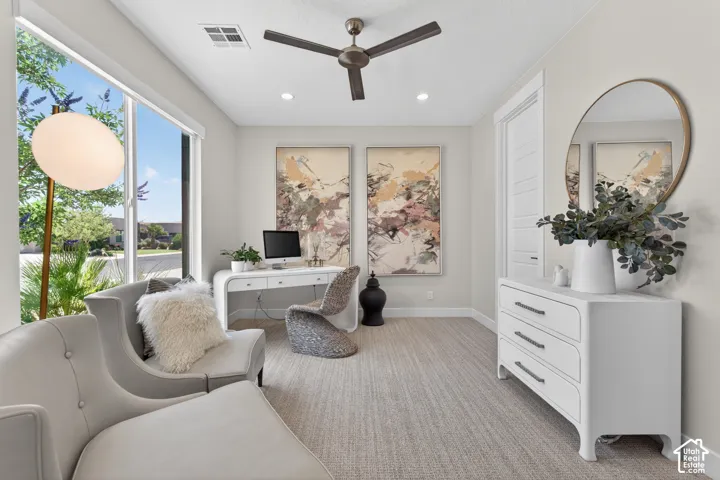 Bright interior space featuring large windows, recessed lighting, and a ceiling fan