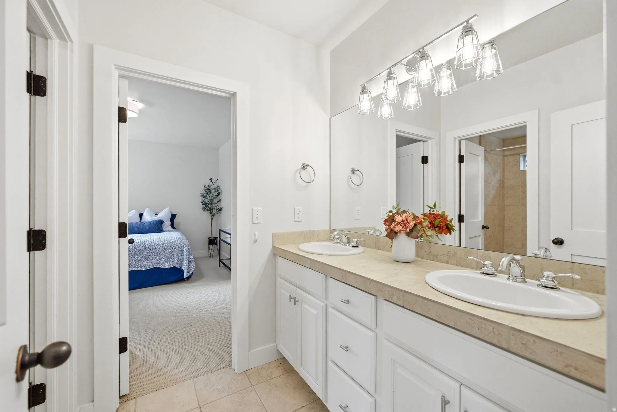 Double vanity featuring two undermount sinks, chrome fixtures, and a six-light vanity bar