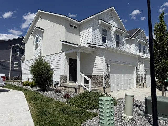 White exterior featuring horizontal siding, stucco, and stone veneer accents