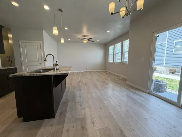 Expansive open-concept living area featuring light wood-finish flooring
