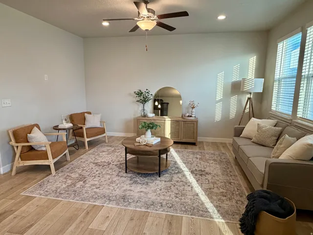 Spacious interior featuring wood-finish flooring, recessed lighting, and a ceiling fan
