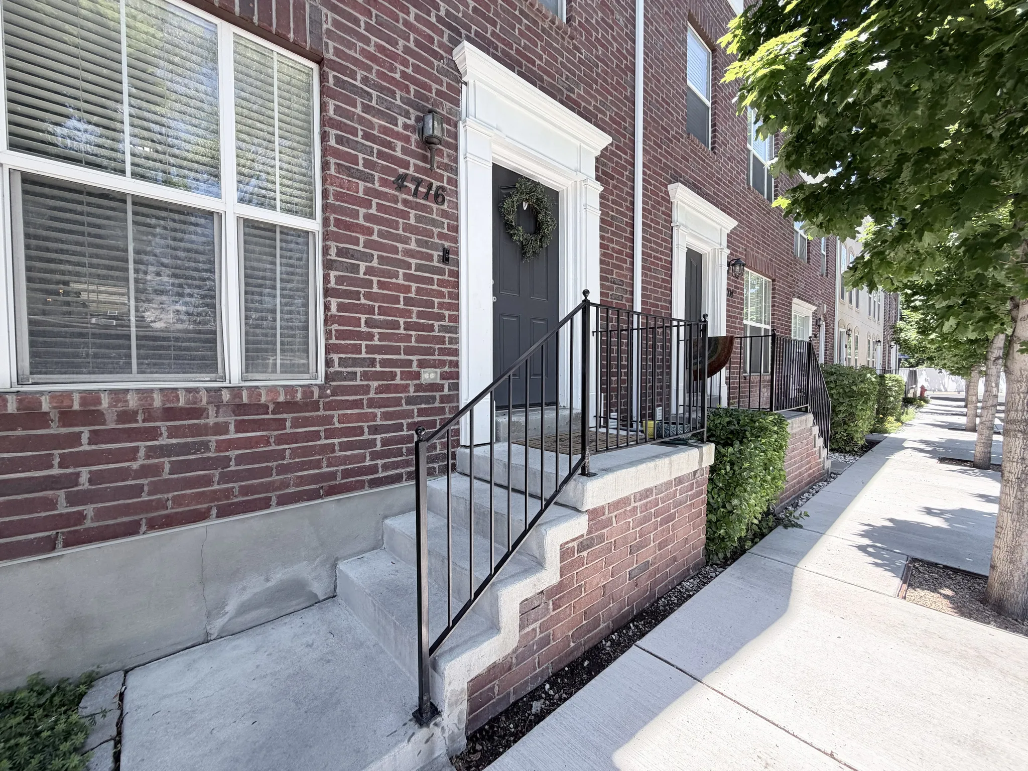 Brick facade featuring a framed entryway with a dark door and white trim