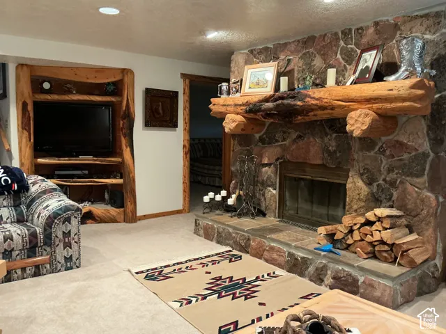 Stone fireplace with a substantial log mantel and hearth