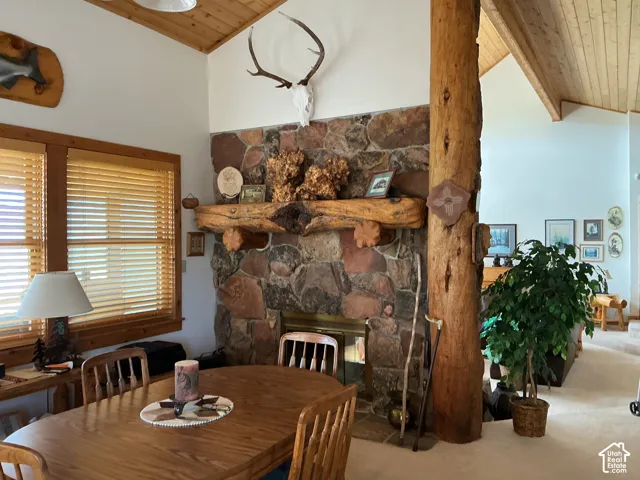 Stone-clad fireplace with a substantial log mantel and integrated firebox