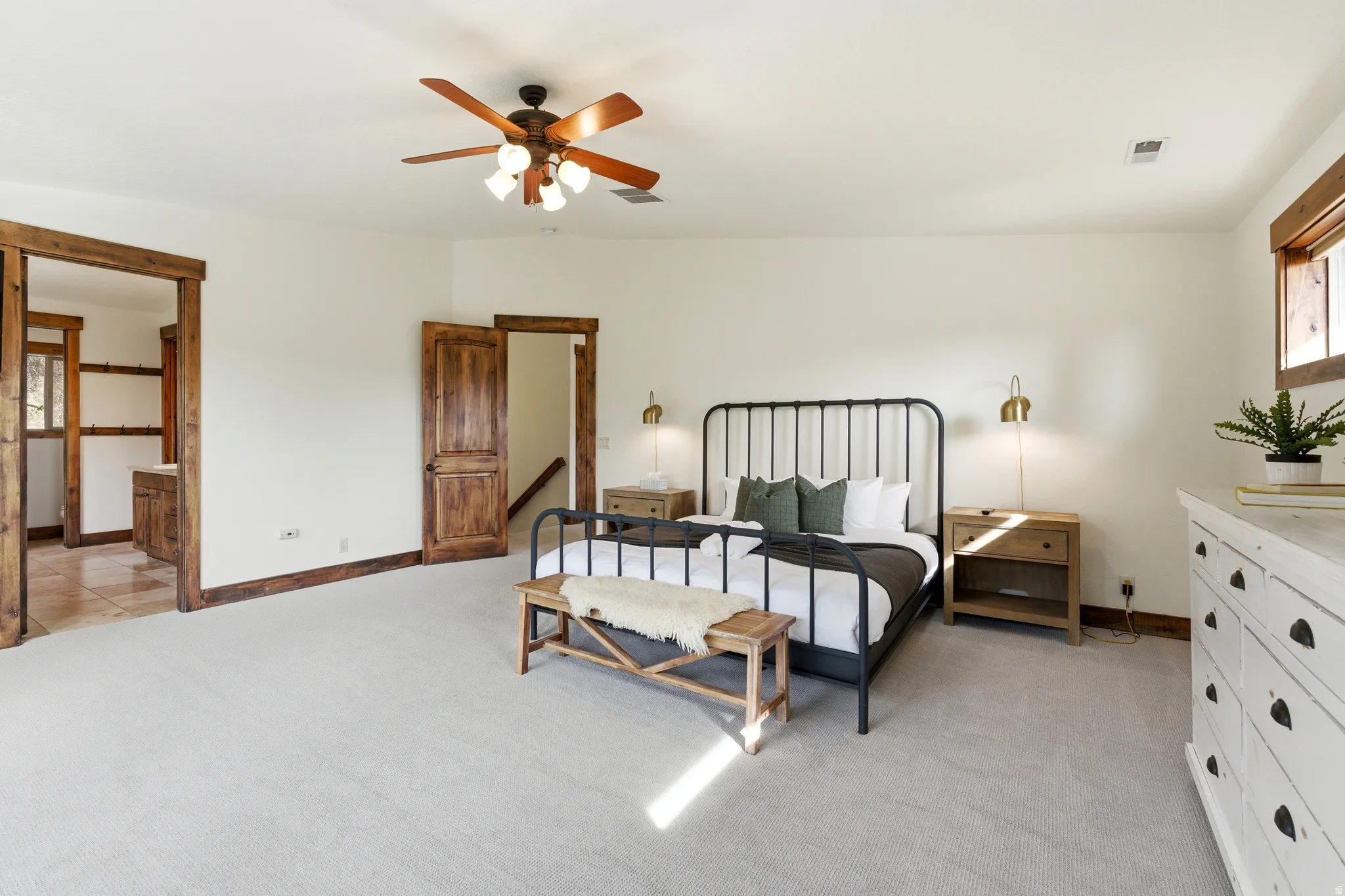 Spacious room featuring light-toned carpeting and white wall finishes