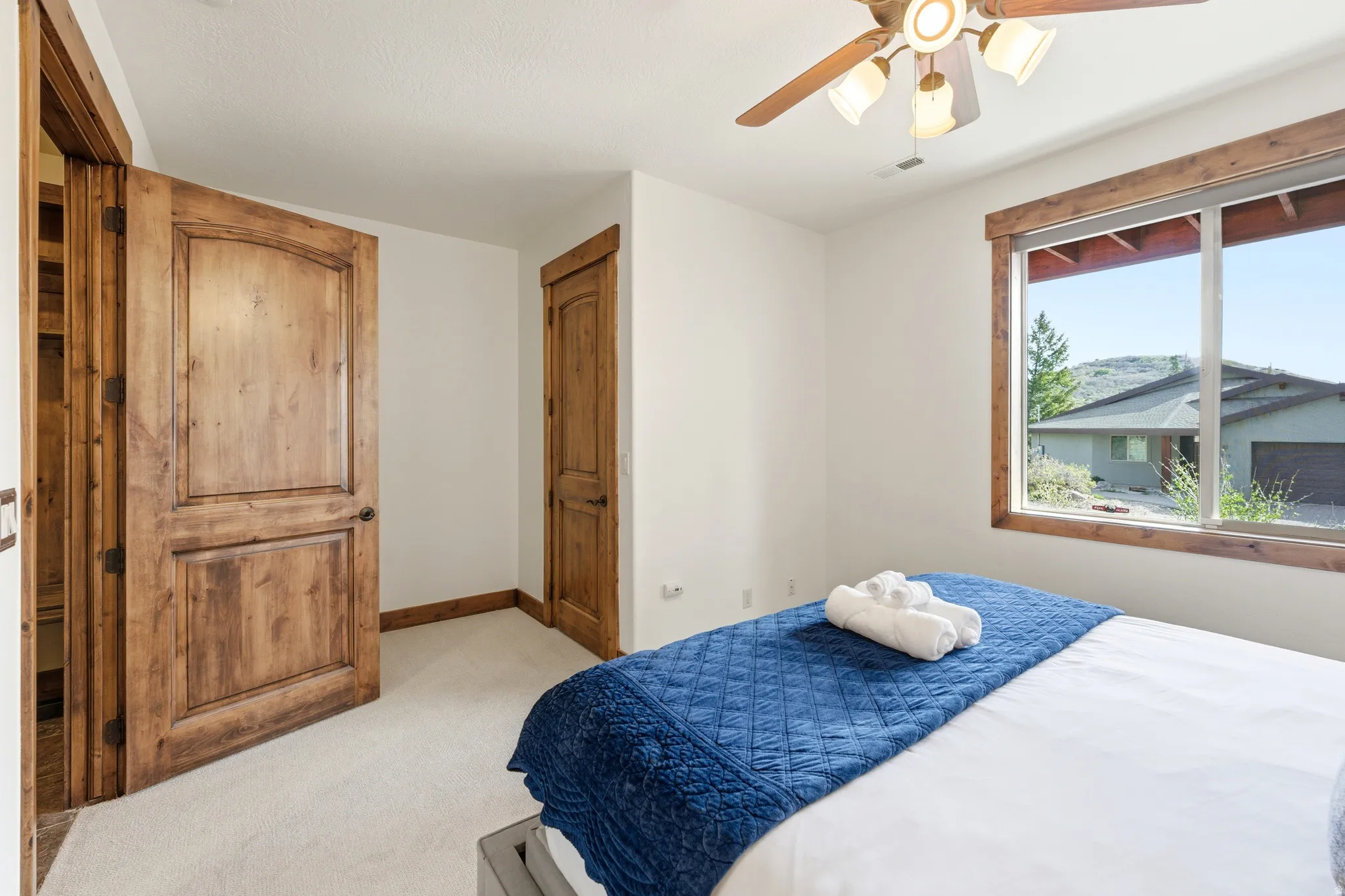 Bedroom featuring light-toned carpet flooring and white painted walls