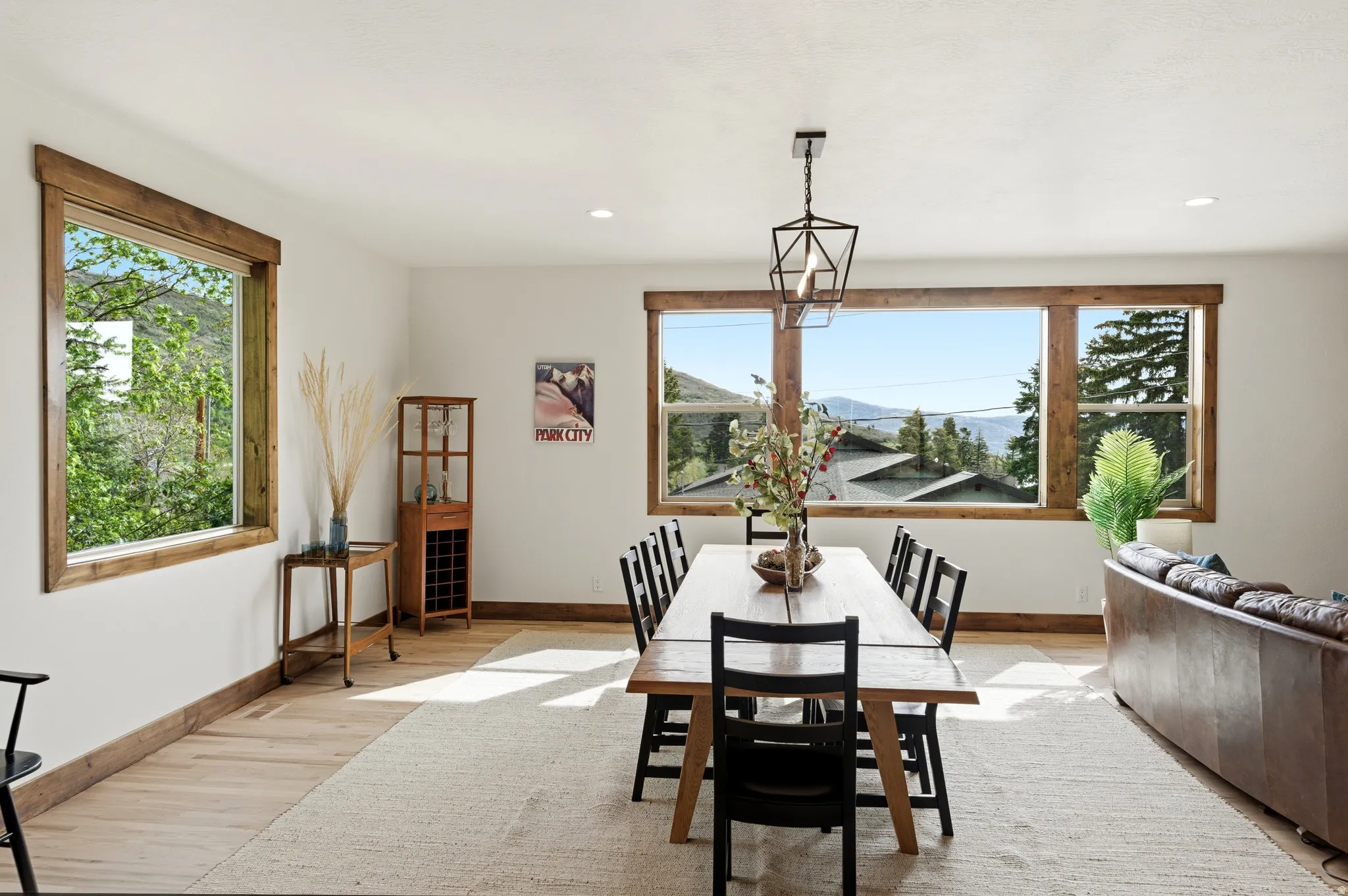 Dining area with natural wood-finish flooring and white walls