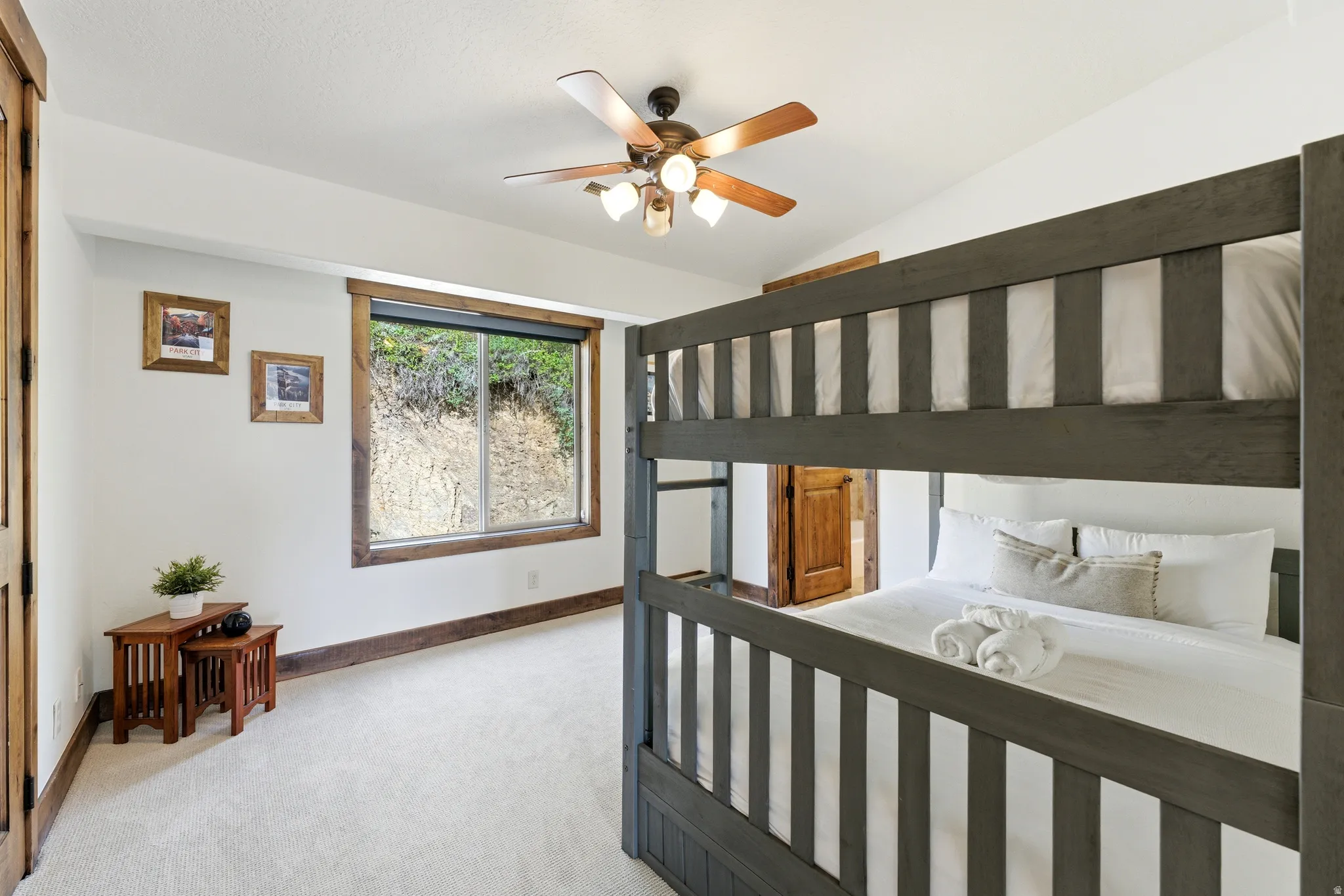 Spacious room featuring light-toned carpeting and white walls