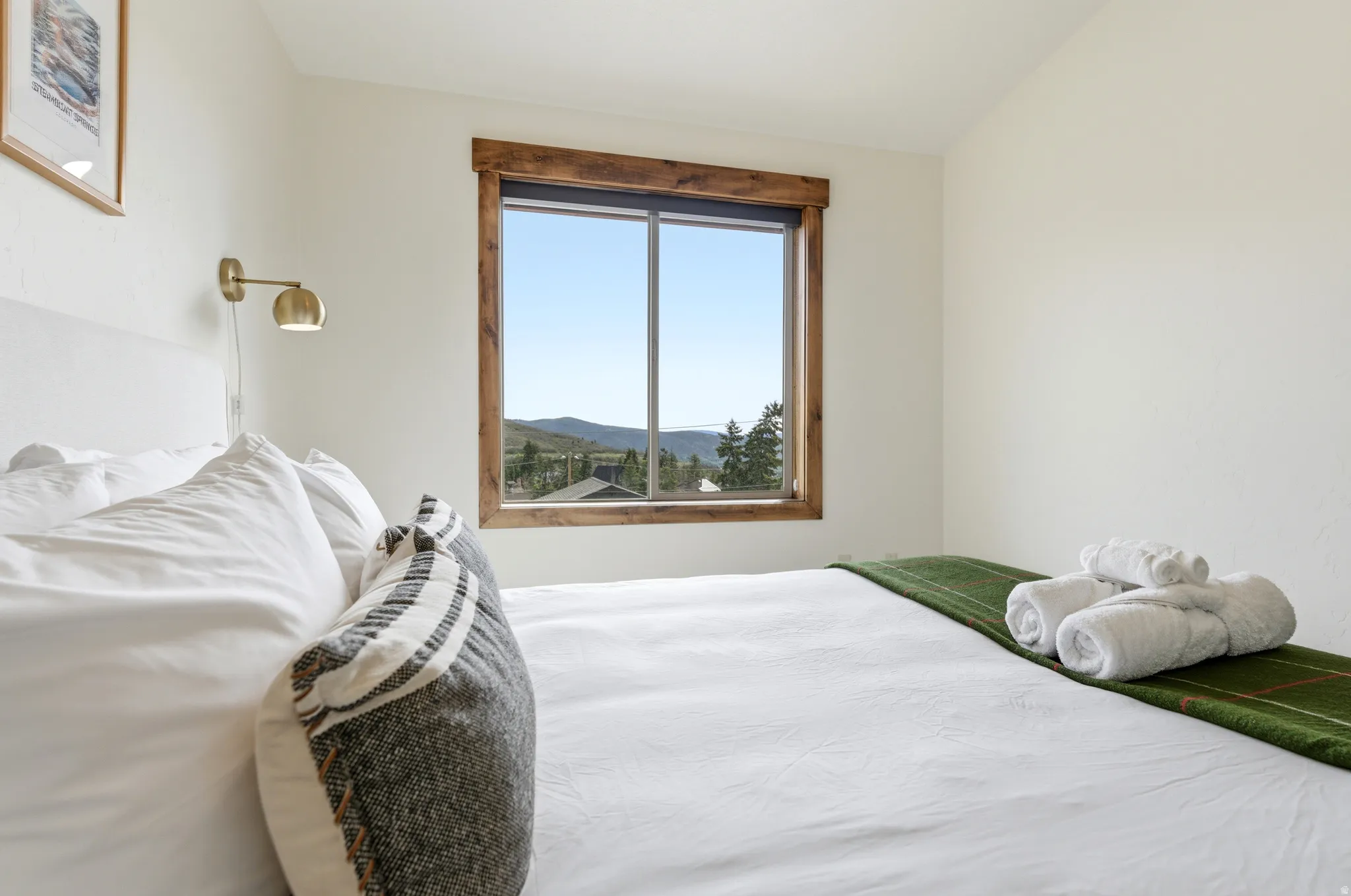 Window featuring wood-finish trim and mountain scenery