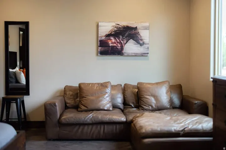 Neutral-toned walls complement a window with natural light and dark-toned flooring