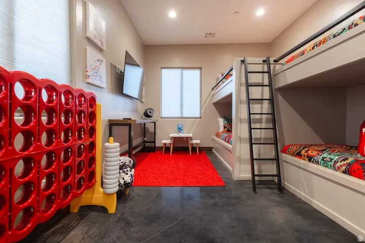 Room featuring built-in bunk beds with ladders, recessed lighting, and hard flooring