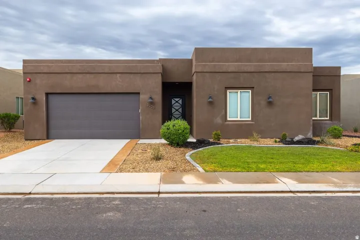 Contemporary stucco exterior featuring a flat roofline and dark brown finish
