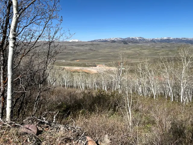 Expansive mountain scenery featuring a distant snow-capped range