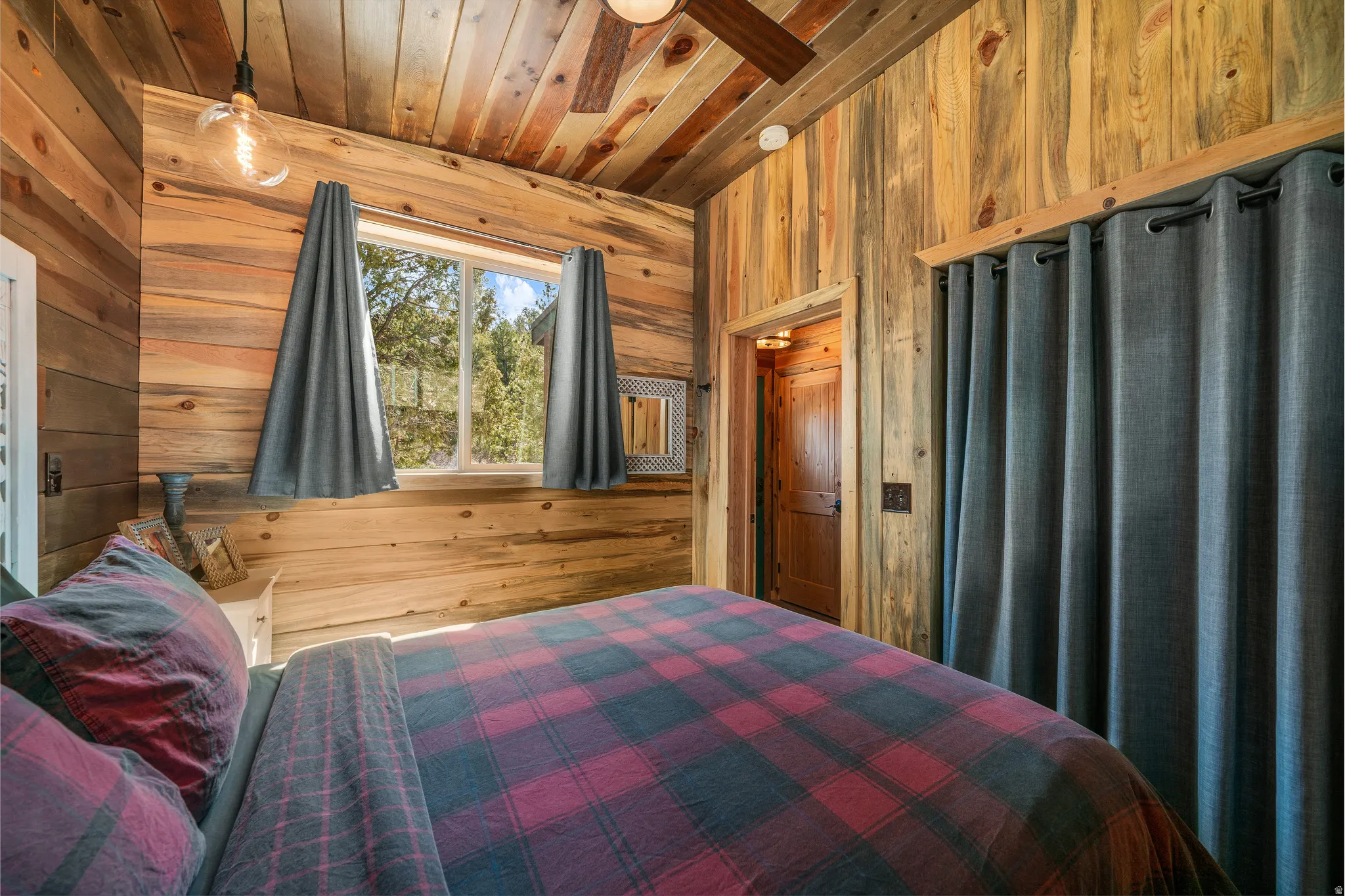 Wood-paneled room with natural wood ceiling and walls